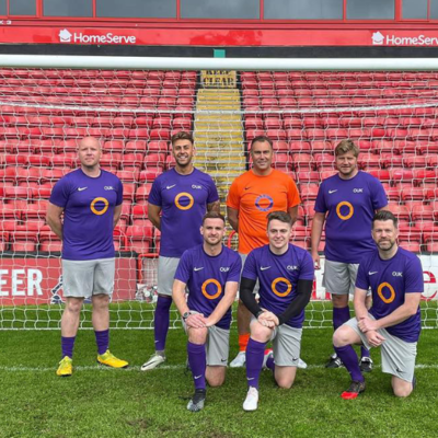 Photo of the team in Outsource UK football kit for charity game