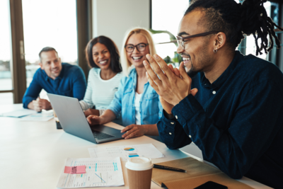 Group of people at work smiling and talking