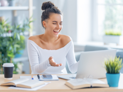 A person smiling at a laptop