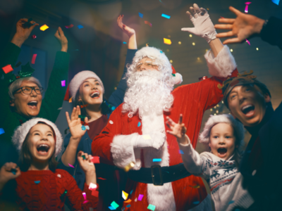 A group of people celebrating Christmas with Santa Claus