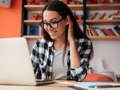 Person working at a laptop, smiling