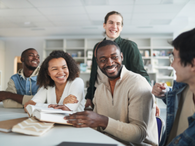 A group of people sitting at a table and smiling