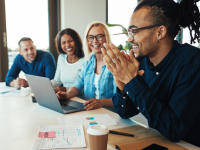 Group of people at work smiling and talking