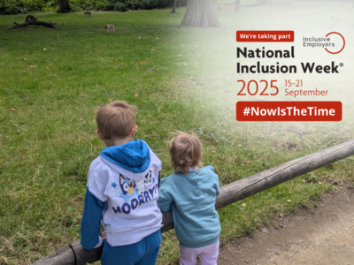 Two children are looking at the animals in the zoo