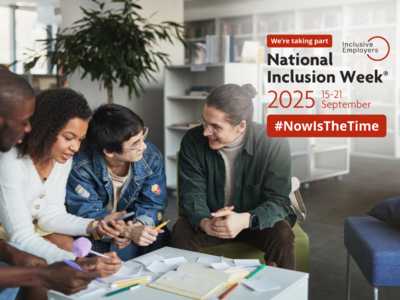 A group of people sitting around a table in an office